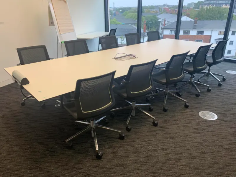 Meeting room office desk and chairs ready to be cleared