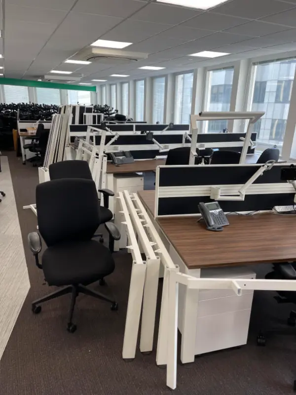 Office Chairs, tables and desks stacked together ready to be cleared