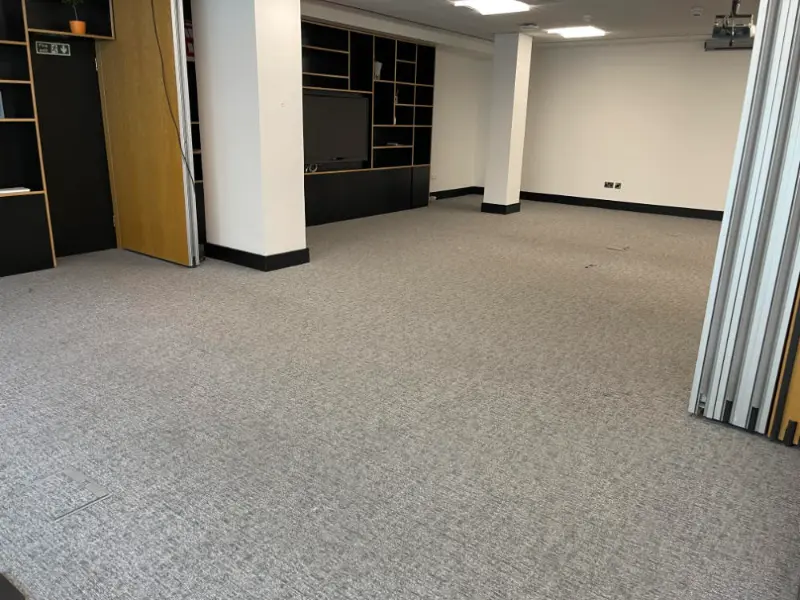Office floor cleared of items and waste