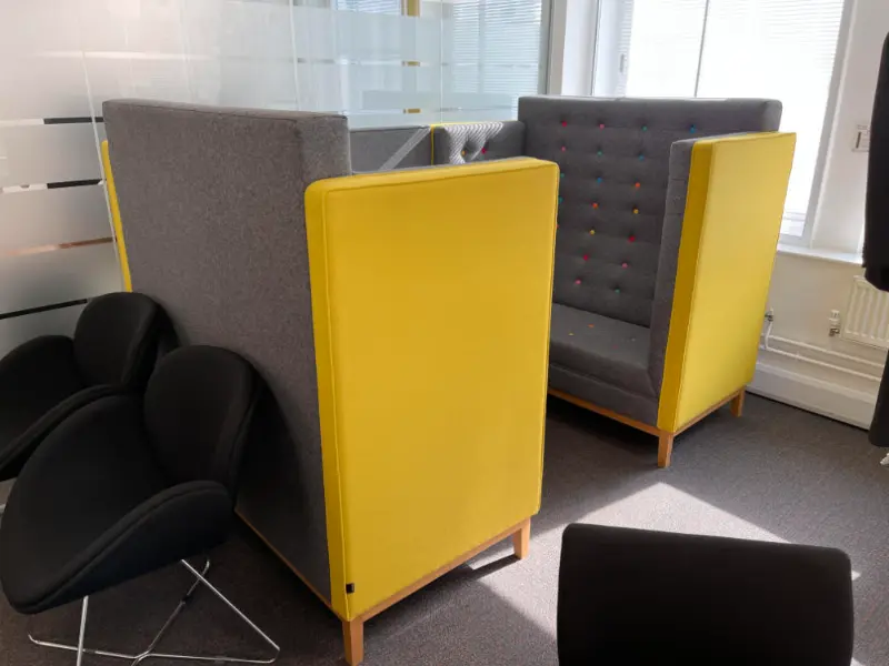 Grey and yellow office sofa booths ready to be moved