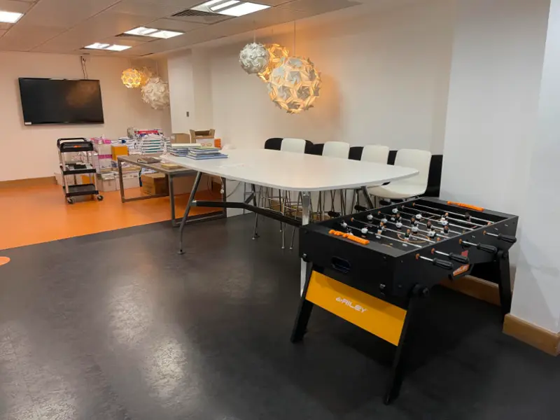 Office leisure room with table and football arcade game
